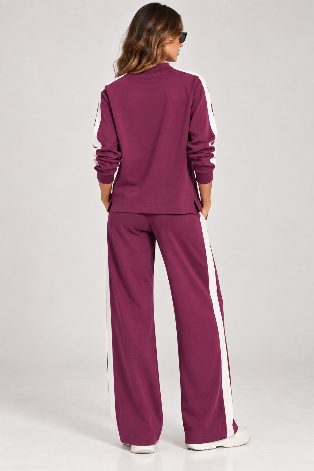 Vista posteriore della tuta donna Vanny Tiffosi magenta con bande bianche laterali e pantalone a gamba larga.