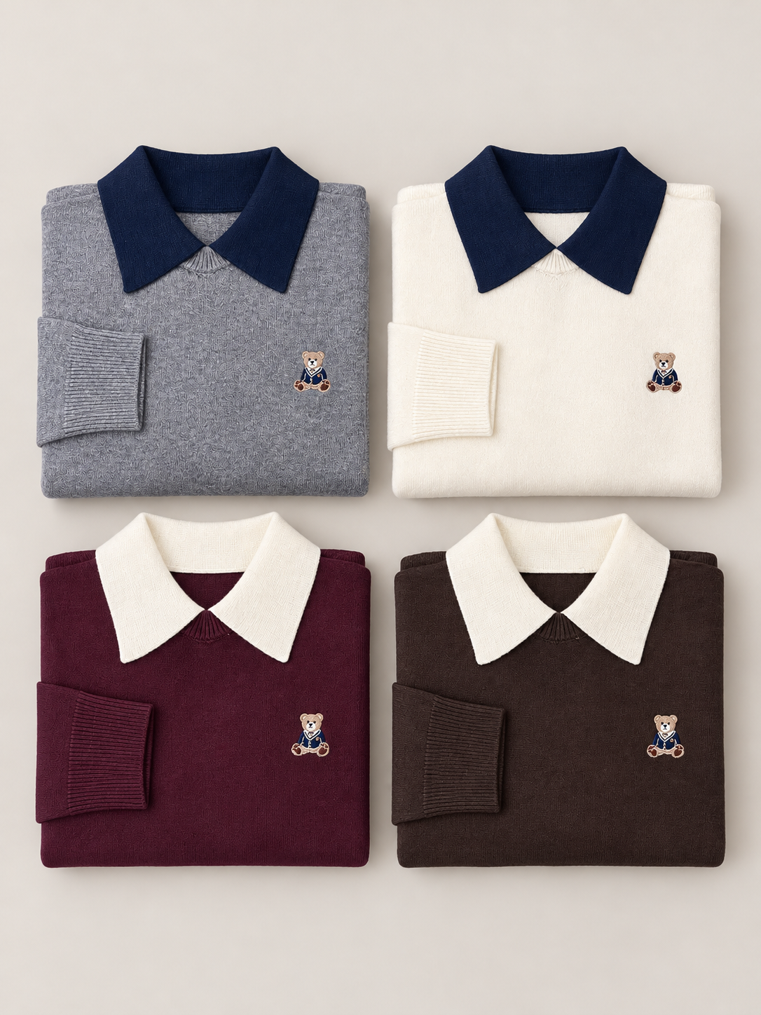 Maglioni donna Teddy piegati nei colori grigio, panna, bordeaux e cioccolato, con colletti a contrasto e ricamo orsetto.
