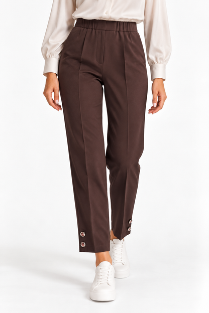 Pantalone Capri donna color cioccolato indossato, vista frontale con vita elasticizzata e bottoni sul fondo.