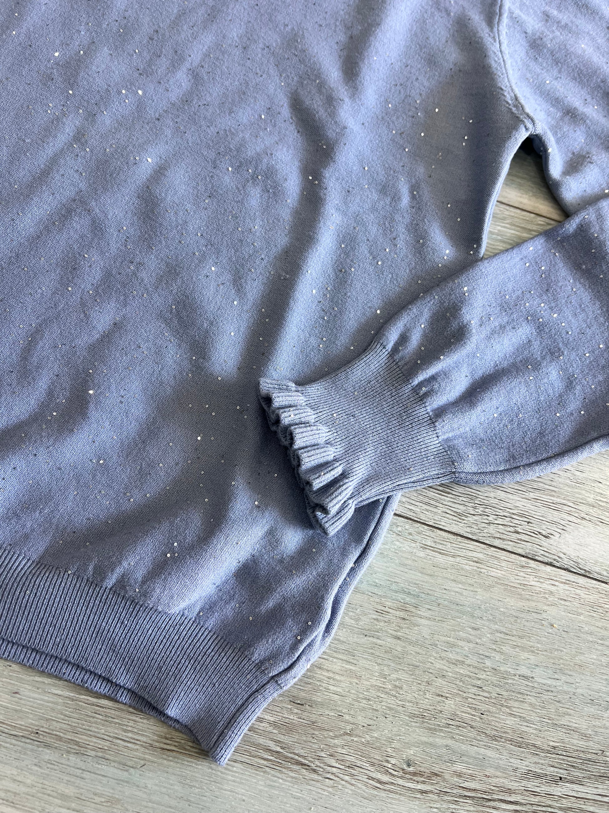 "Dettaglio tessuto lurex viscosa - effetto luminoso e morbido al tatto"