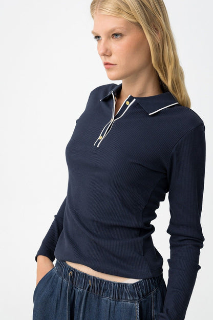 Dettaglio Polo Coste Glacier - vista laterale che mostra la vestibilità slim fit e la texture della maglia a coste con profili bianchi