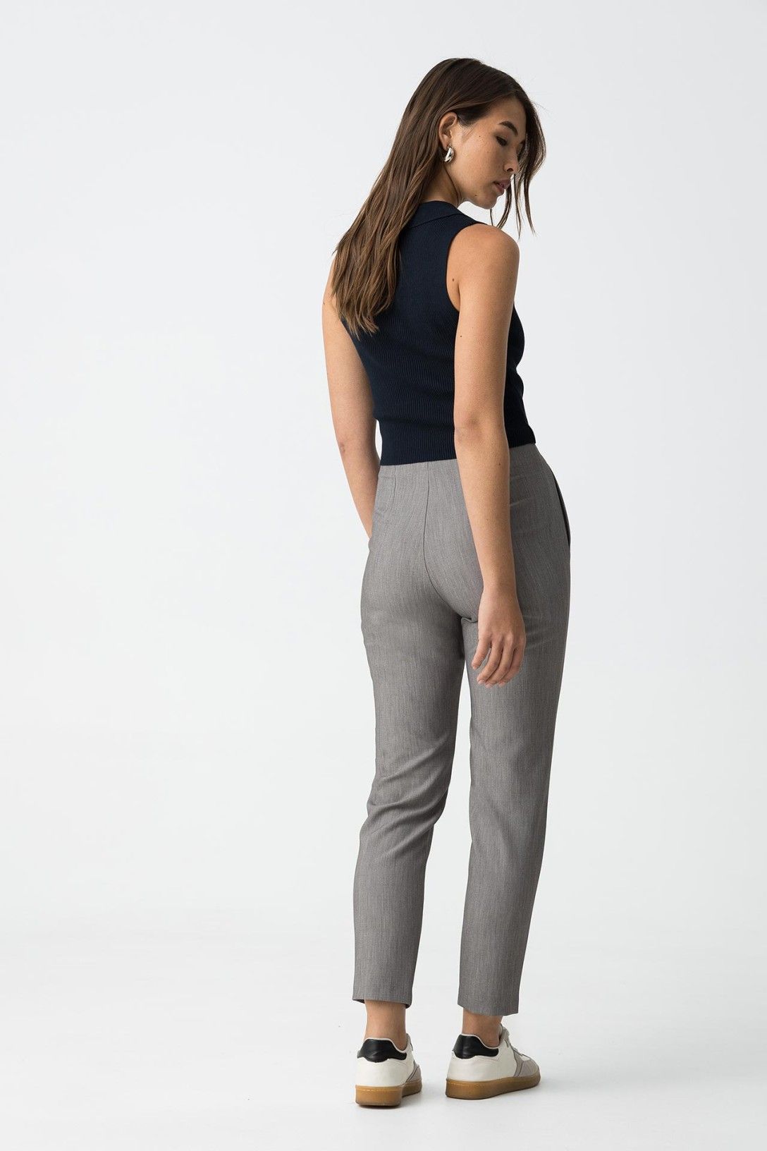 "Vista posteriore pantaloni slim fit donna in grigio con tasche posteriori"