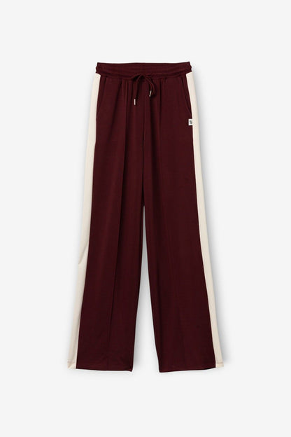 Pantalone della tuta donna Vanny Tiffosi magenta a gamba larga con elastico e coulisse in vita, bande laterali bianche.